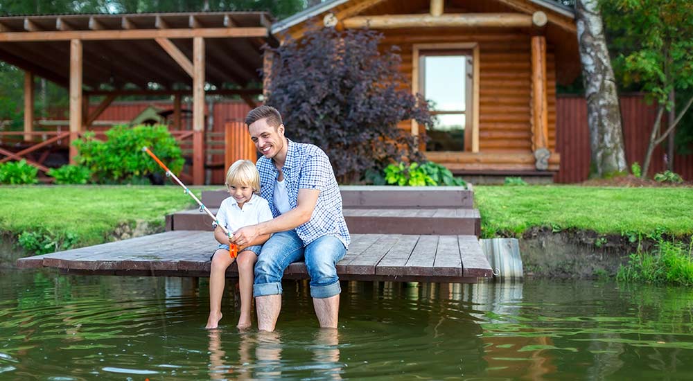 Father and son fishing at their lakeside home