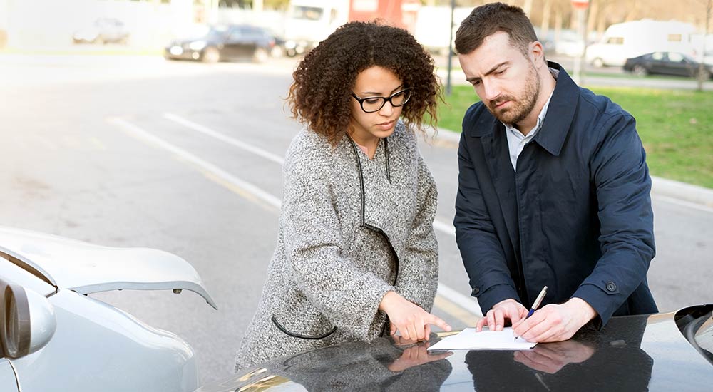 Two people exchanging information after an accident