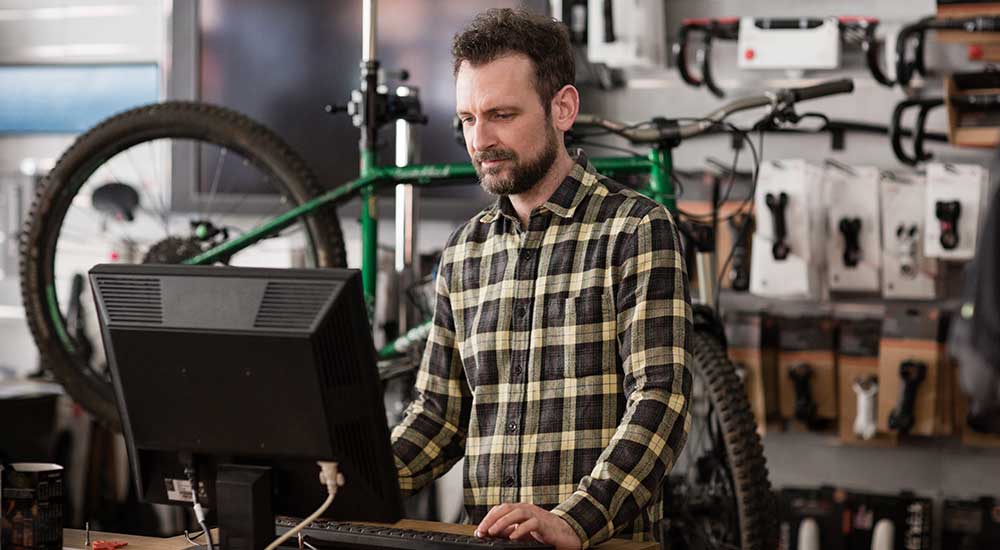 Retail bike shop owner working