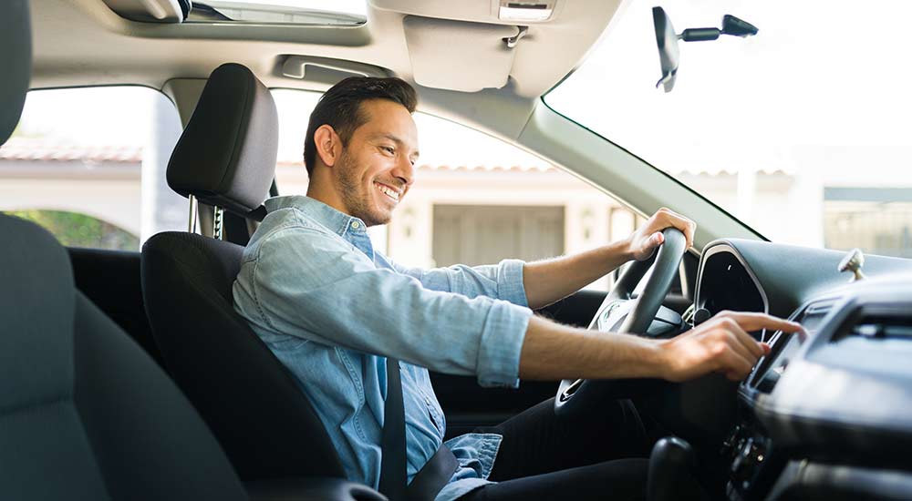 Man trying out the features of a new car