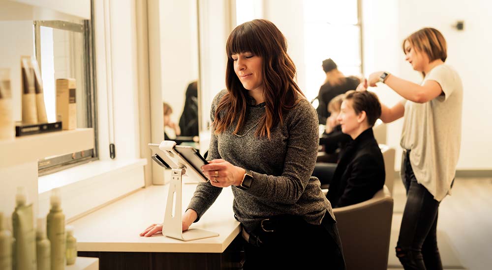 Woman cutting hair in a hair salon