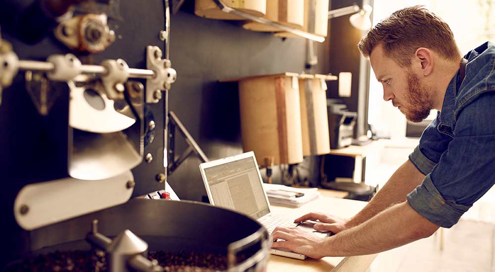 Shop owner on laptop  